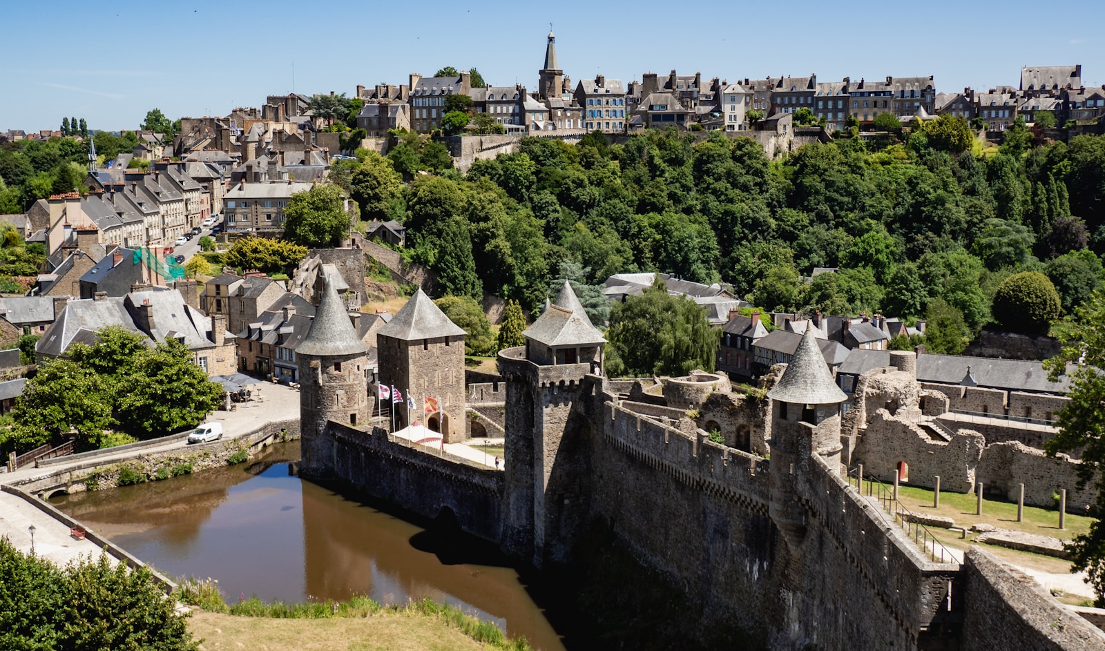 A walled medieval town sits atop a hill.