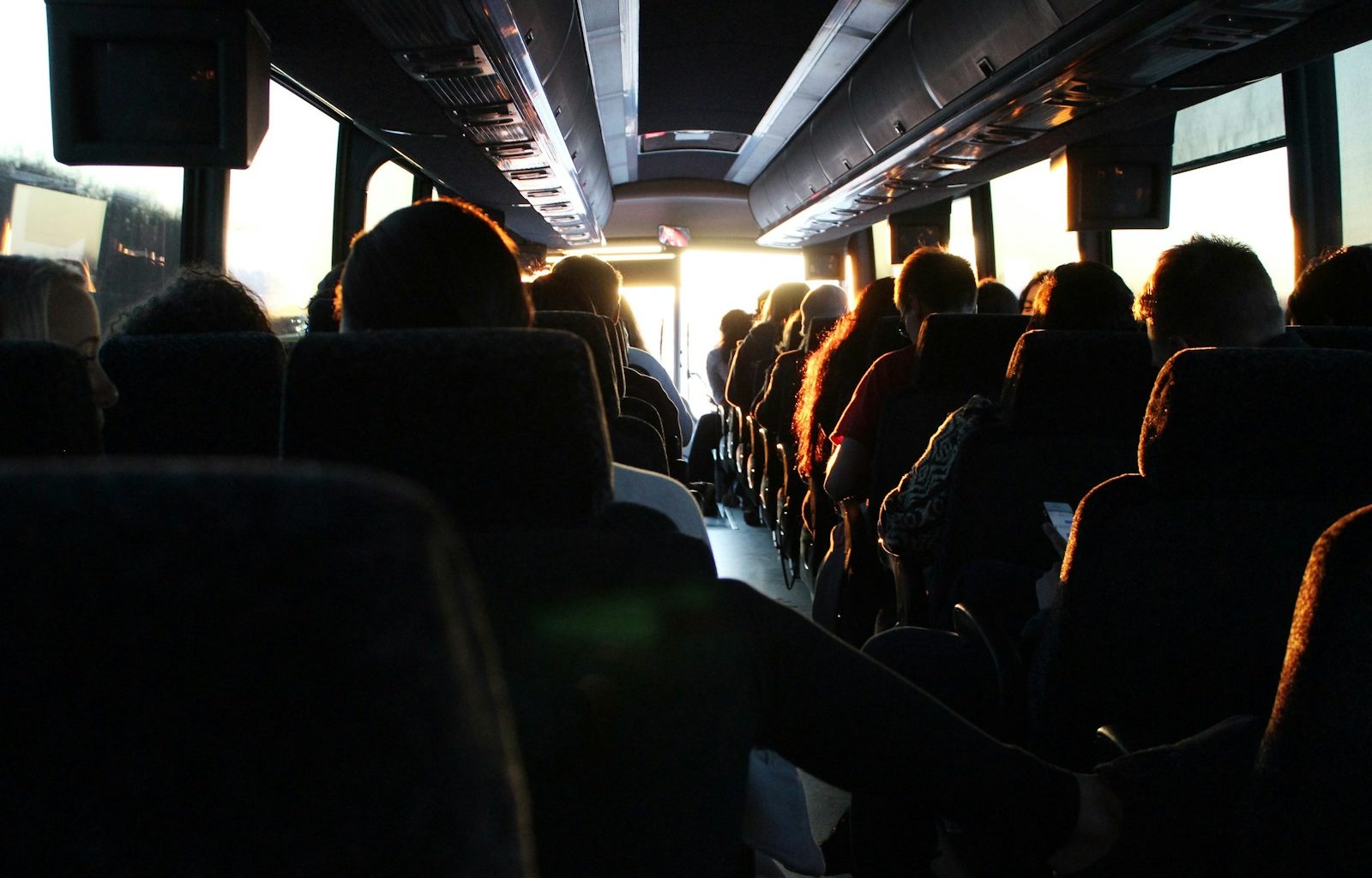 people riding passenger bus during daytime