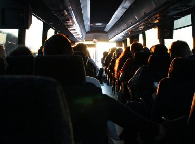 people riding passenger bus during daytime