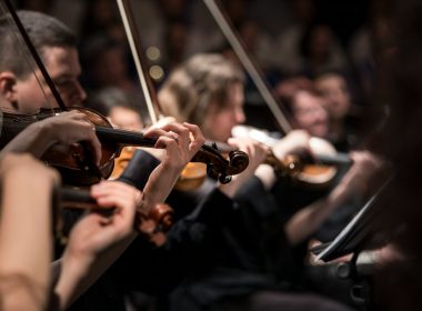 people playing violin inside dim room