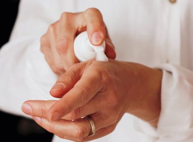 person holding white round ornament