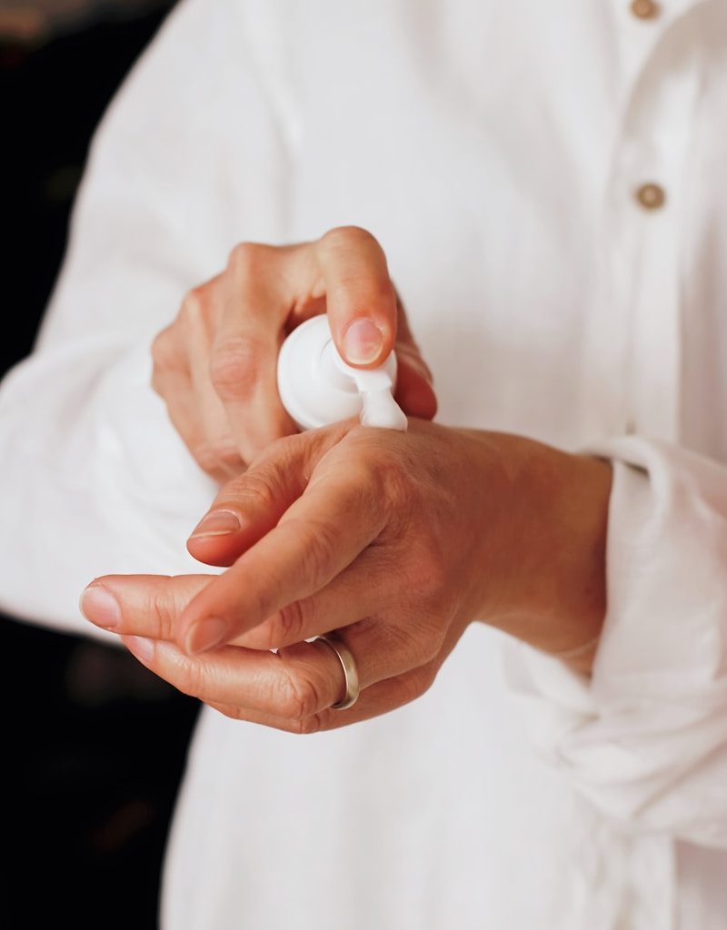 person holding white round ornament