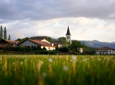 green grass field and houses during daytime