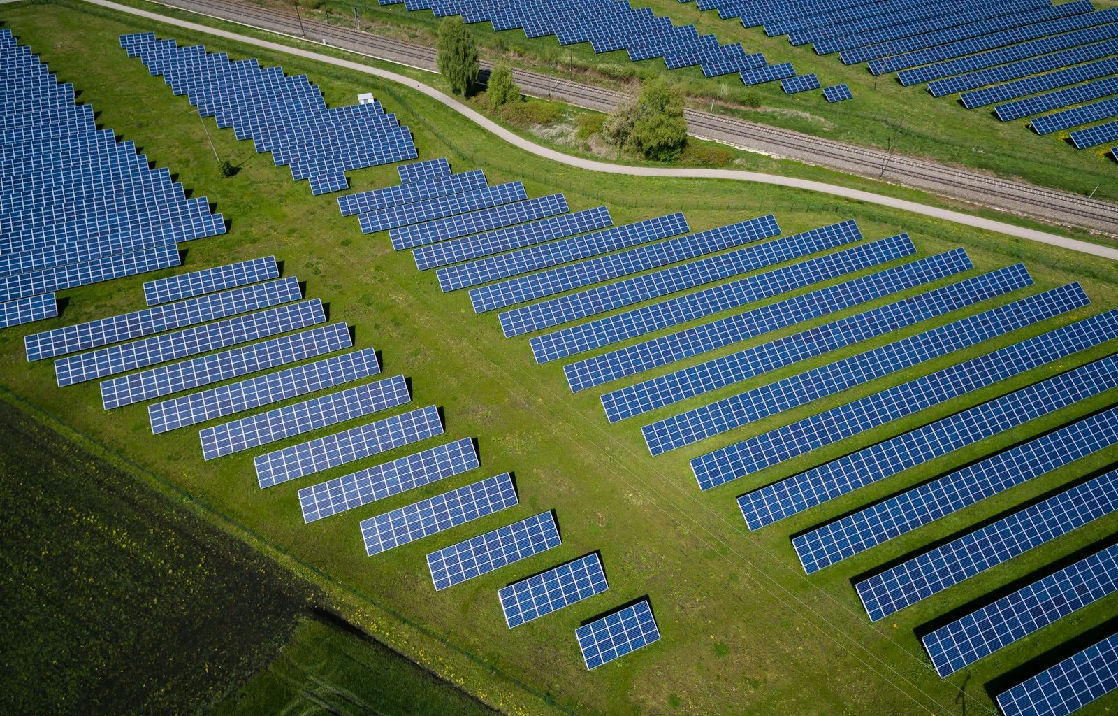 aerial photography of grass field with blue solar panels