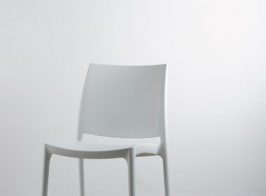 white armless chair near white wall