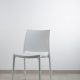 white armless chair near white wall
