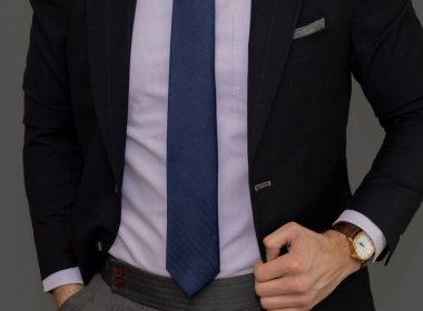 man in black suit jacket and blue necktie