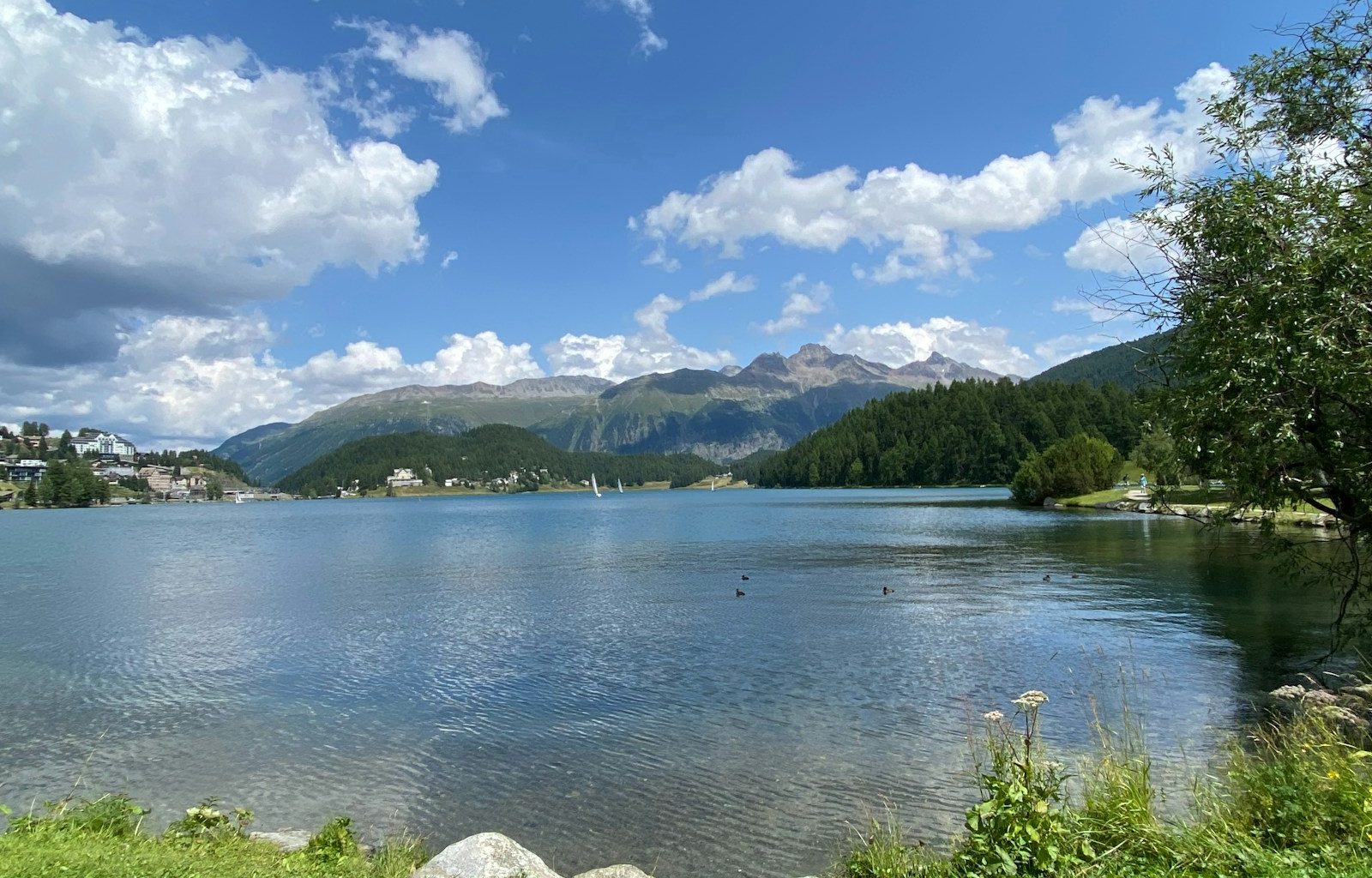 a body of water with mountains in the background