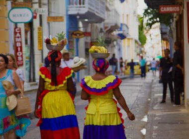 a couple of women walking down a street next to each other