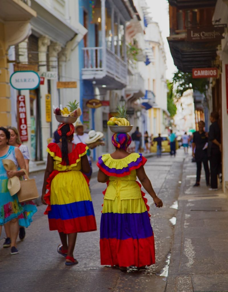 a couple of women walking down a street next to each other