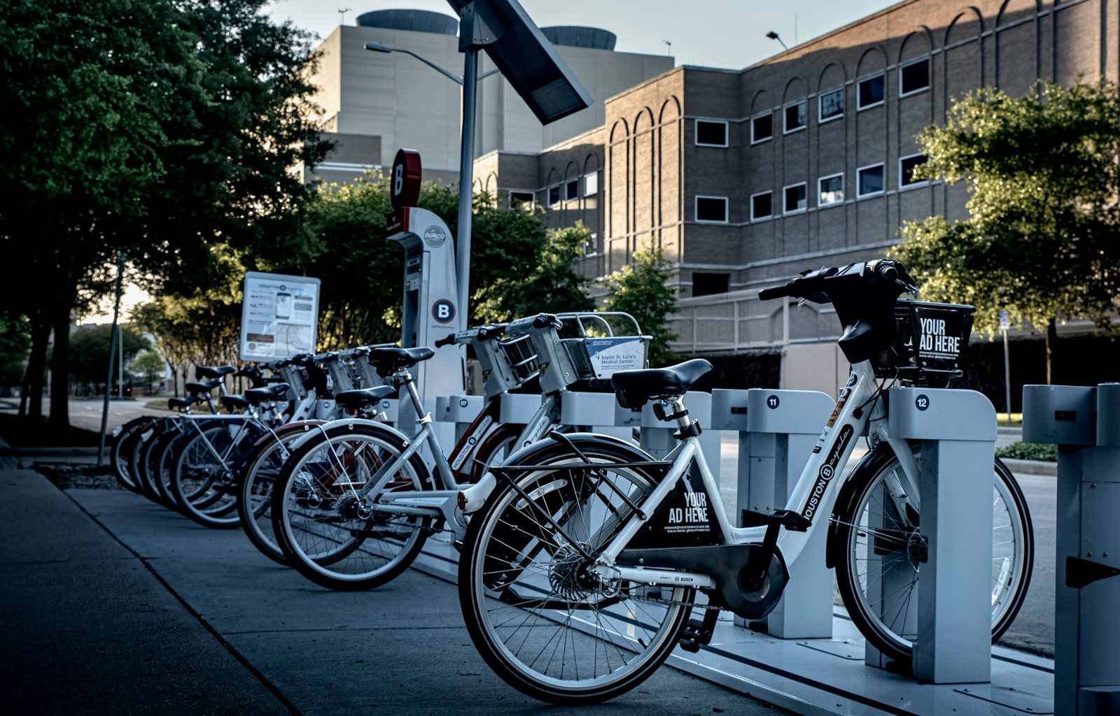 black and silver bicycle parked on sidewalk during daytime