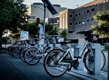 black and silver bicycle parked on sidewalk during daytime