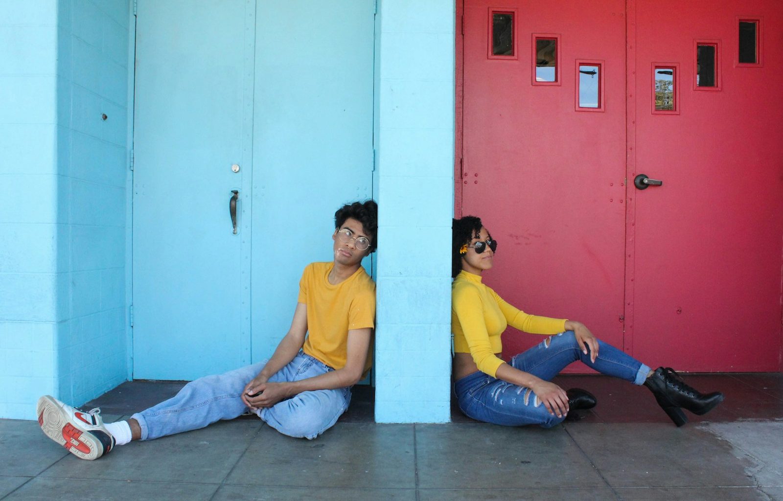 man in yellow polo shirt sitting beside woman in yellow shirt