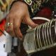 a close up of a person playing a musical instrument