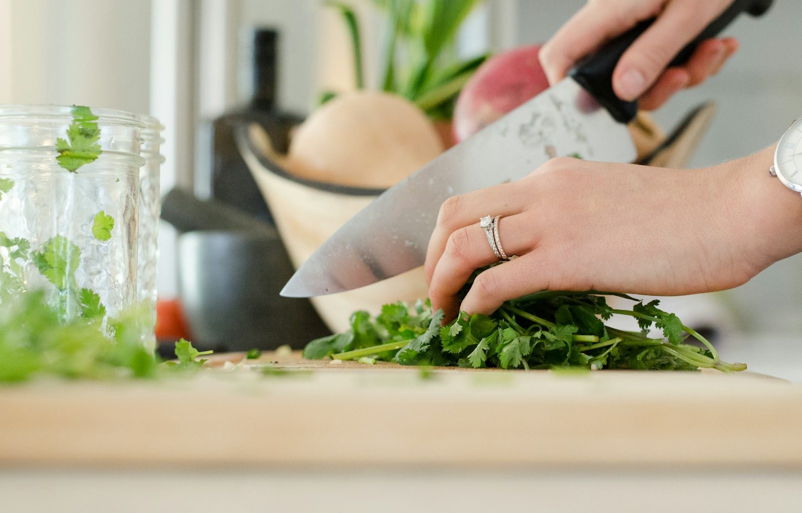 person cutting vegetables with knife