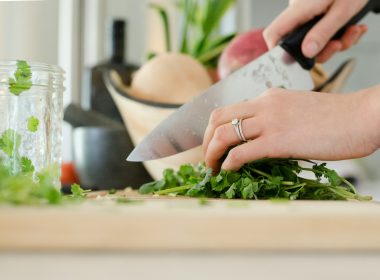 person cutting vegetables with knife