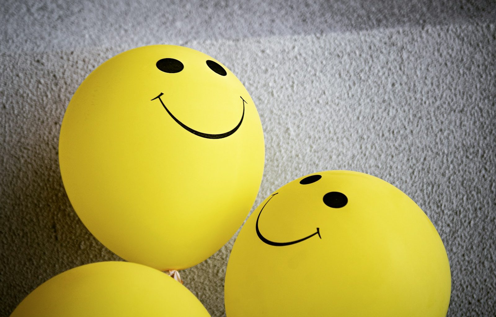 yellow smiley emoji on gray textile