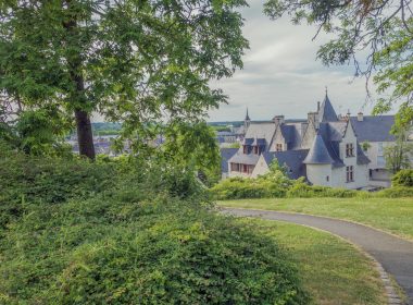 a large house sitting on top of a lush green field