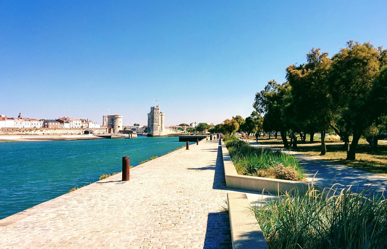 a walkway next to a body of water