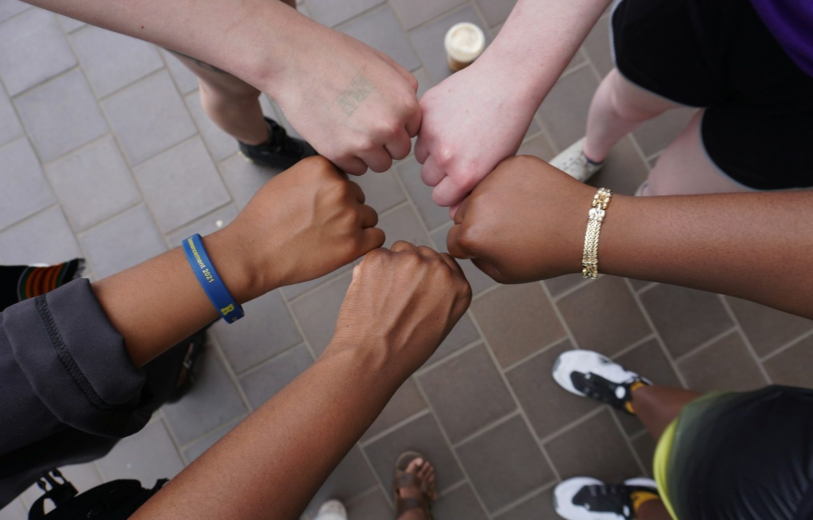 A group of people putting their hands together