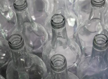 clear glass bottles on brown wooden table