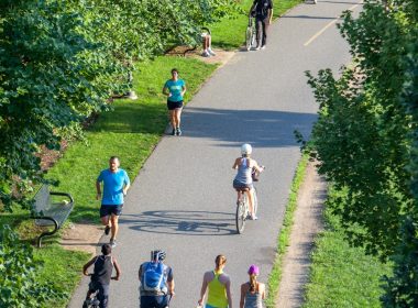 people riding bicycle on road during daytime