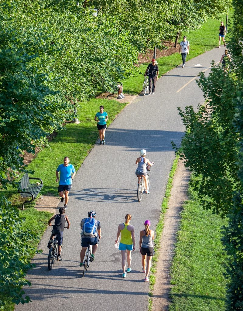 people riding bicycle on road during daytime