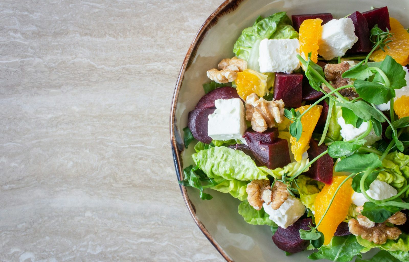 bowl of vegetable salad with walnuts