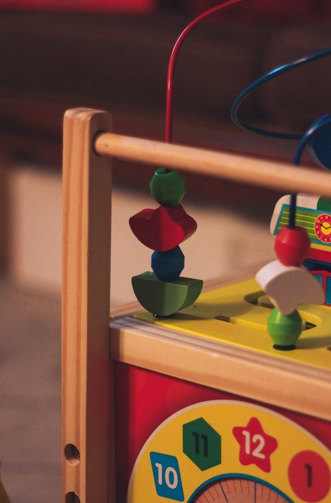 a wooden toy with a clock on top of it