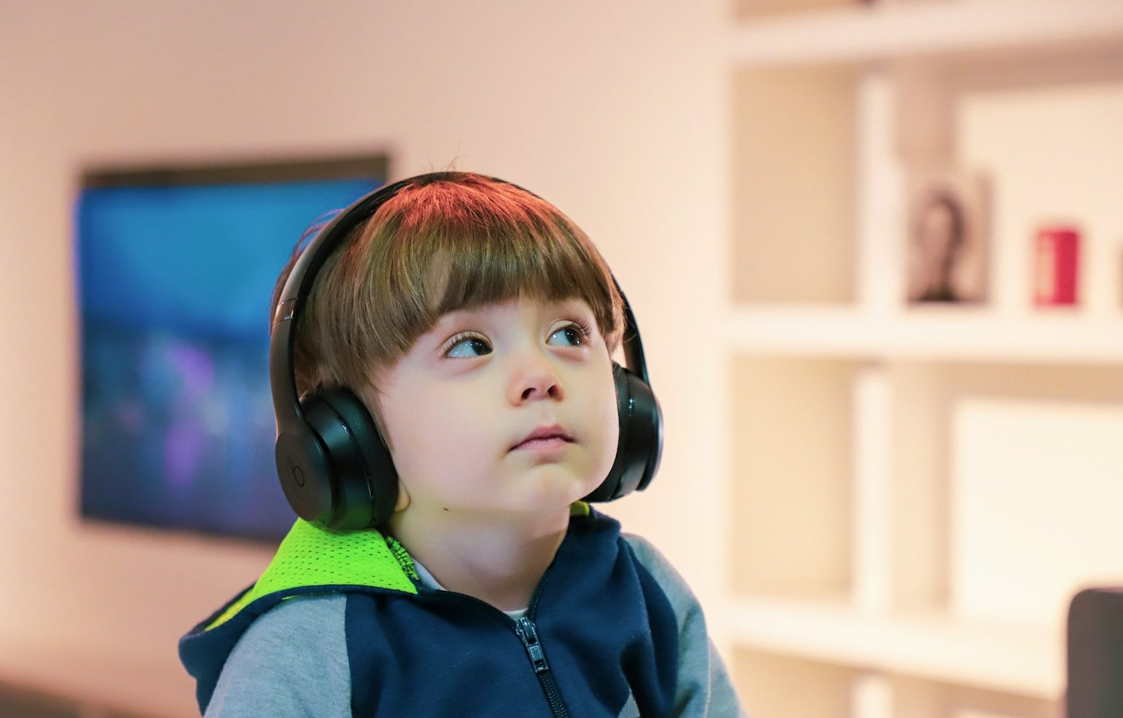 boy near white wooden shelf