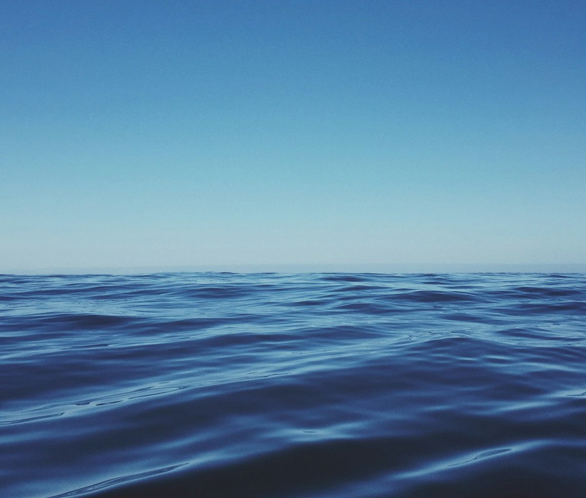 body of water under clear blue sky