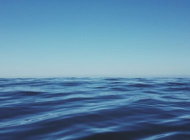 body of water under clear blue sky