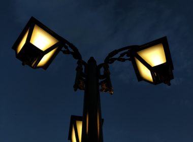 a street light with three lights on each of it's sides