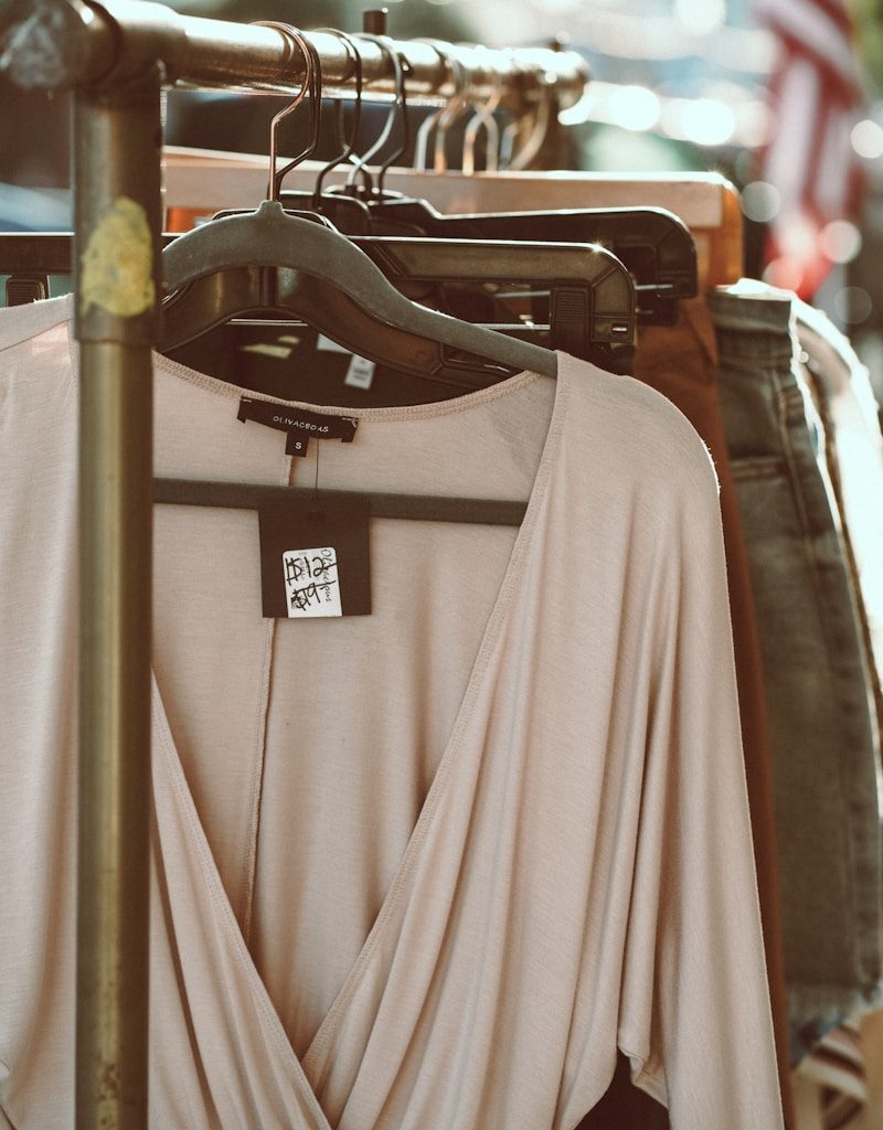 gray long sleeve shirt hanging on black clothes hanger