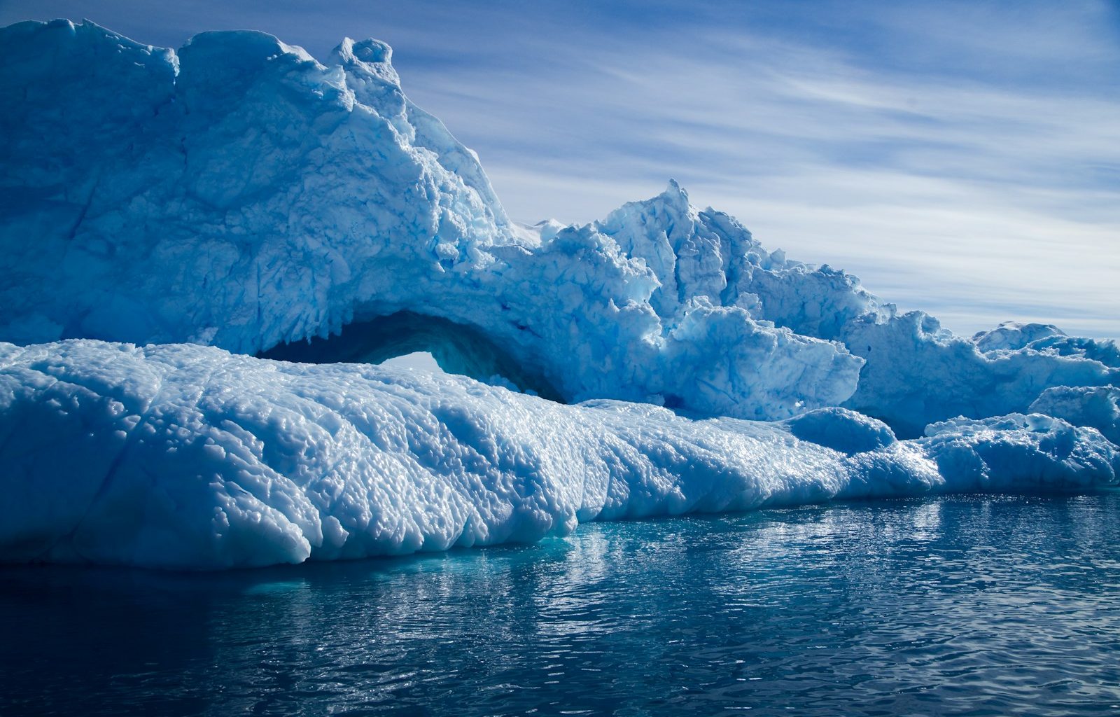 a group of icebergs floating on top of a body of water