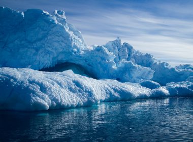 a group of icebergs floating on top of a body of water