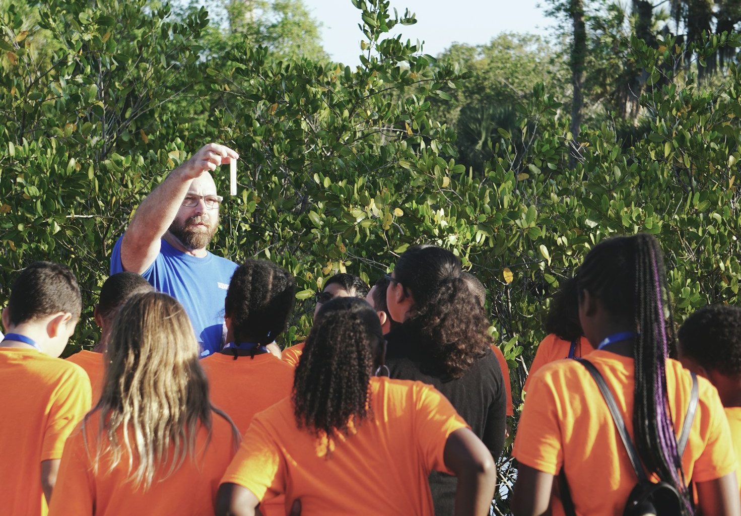 man standing in front of women