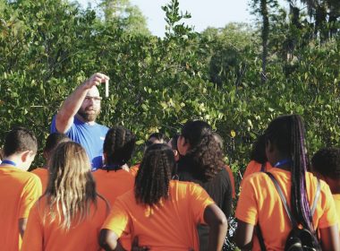 man standing in front of women