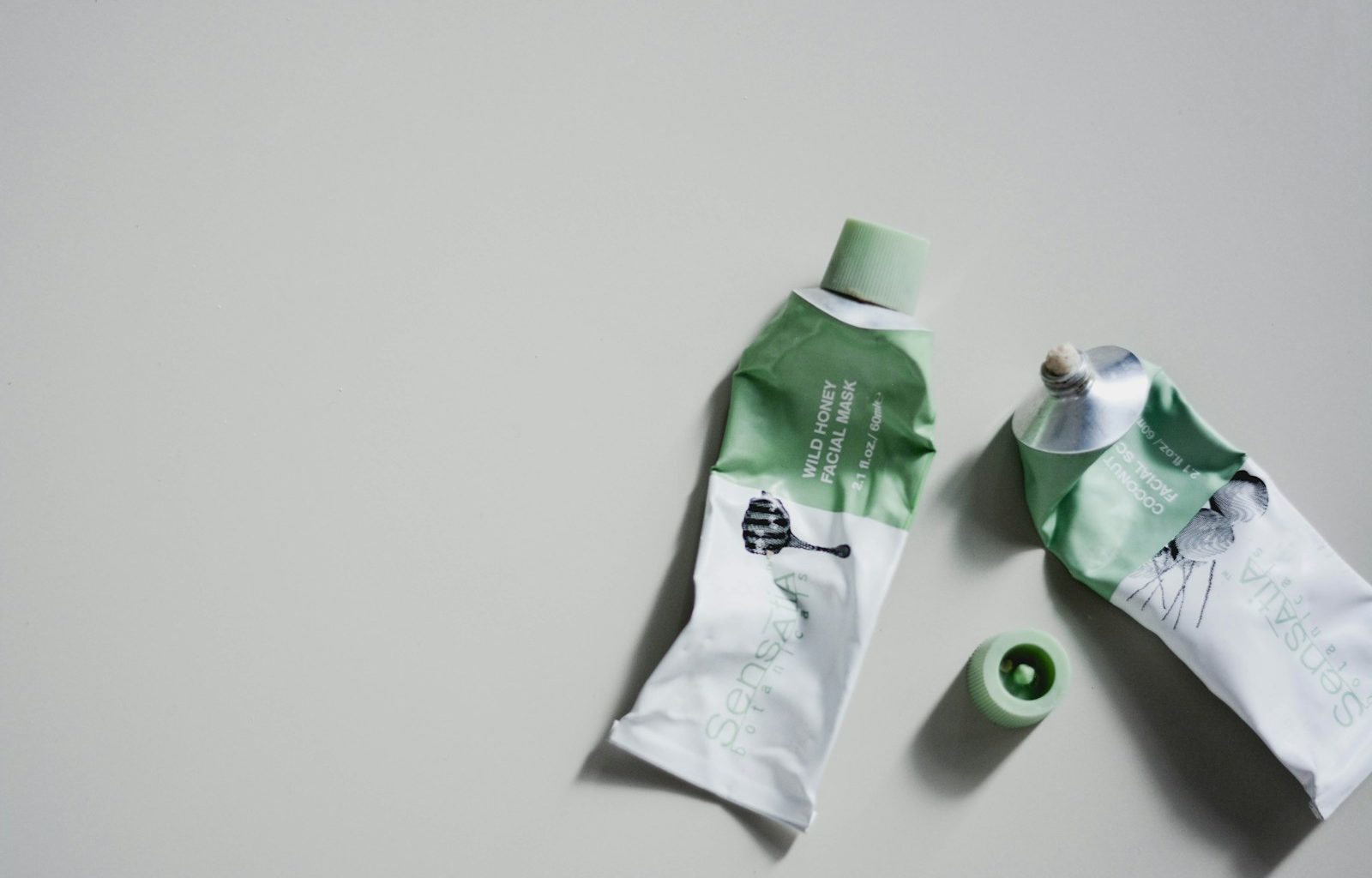 white and green tube bottle