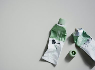 white and green tube bottle