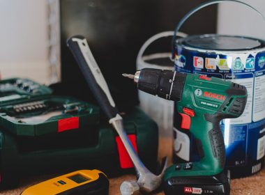 red and black cordless power drill beside black and red cordless power drill