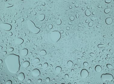 A close up of water droplets on a glass surface