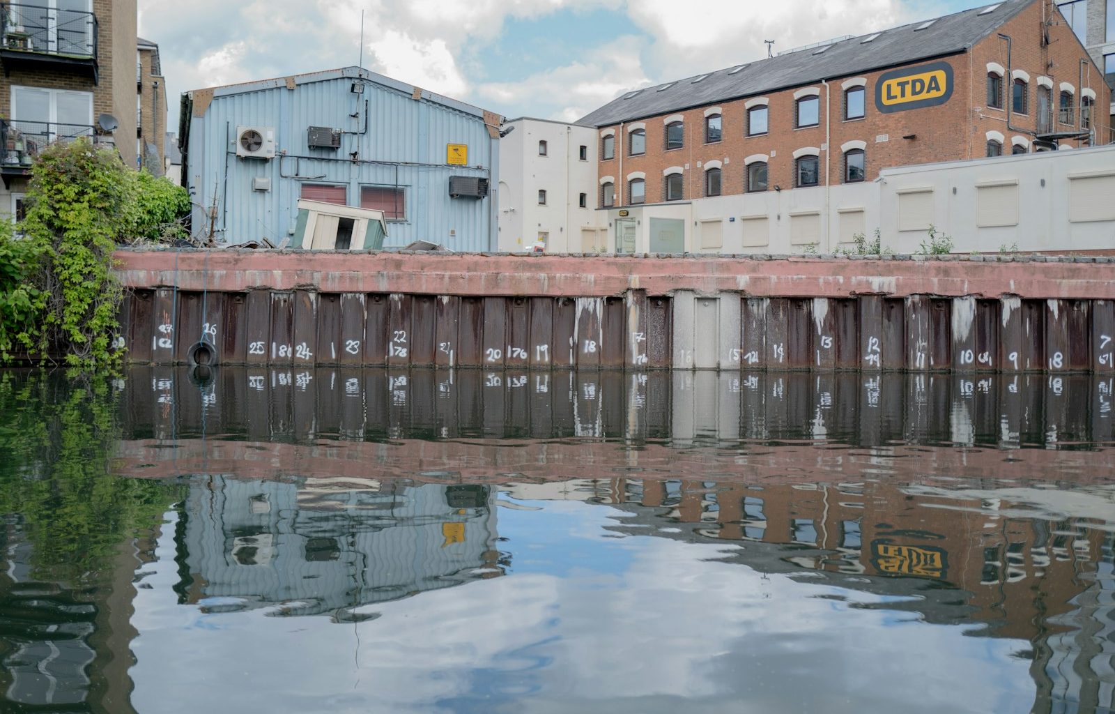 white and brown concrete building beside body of water during daytime