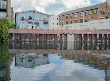 white and brown concrete building beside body of water during daytime