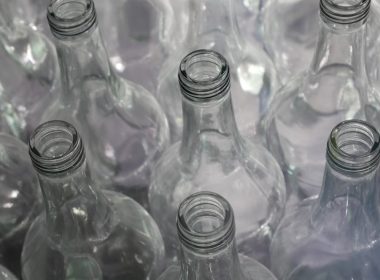 clear glass bottles on brown wooden table