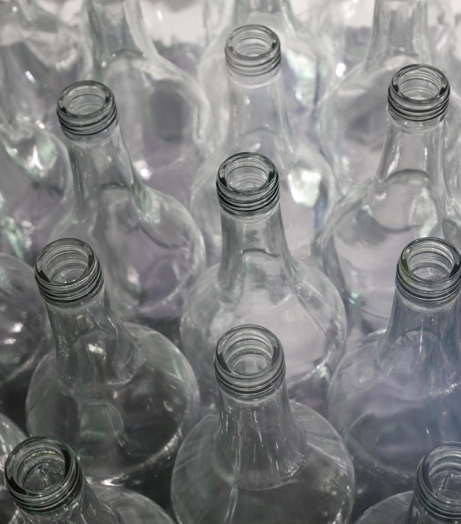 clear glass bottles on brown wooden table