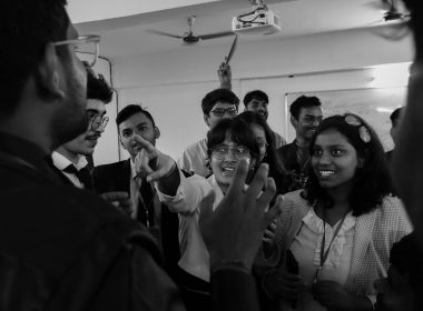 A group of people standing around each other