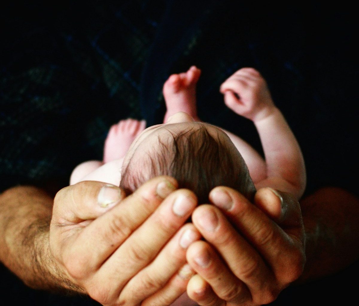 person holding babys hand