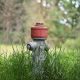 red and gray fire hydrant on green grass field during daytime