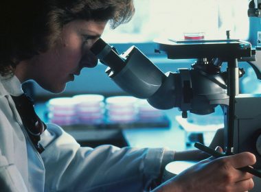 man in white long sleeve shirt holding black dslr camera